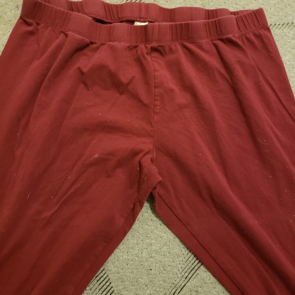 A pair of maroon leggings